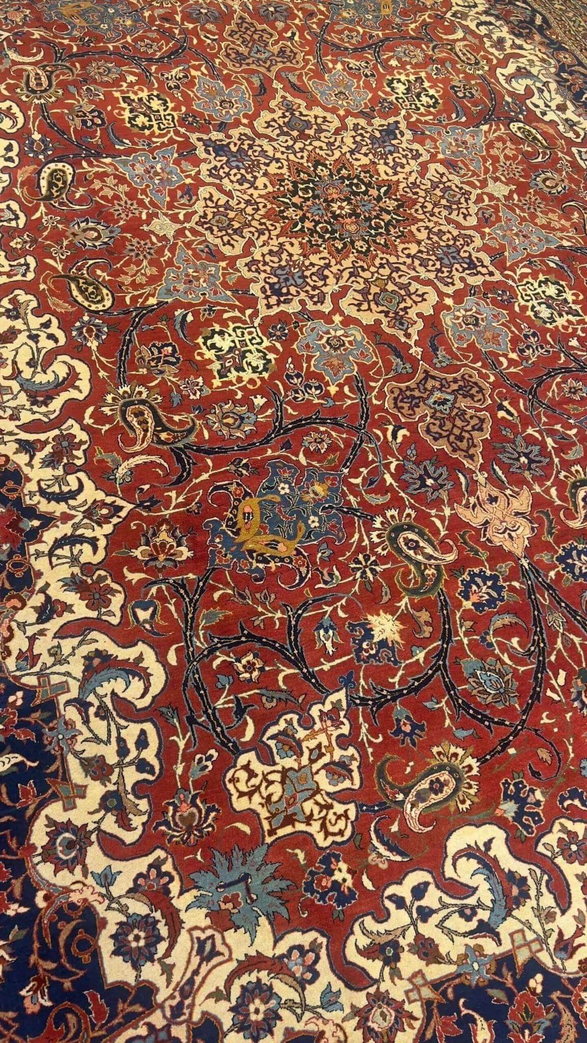 "Antique Persian rug with silk and wool, hand-knotted in Isfahan with vibrant floral patterns"